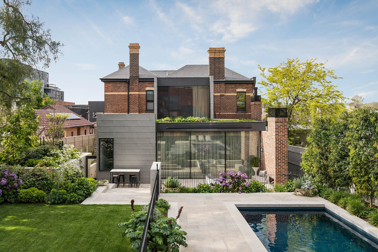 A modern house Armadale Residence with a swimming pool and lawn.